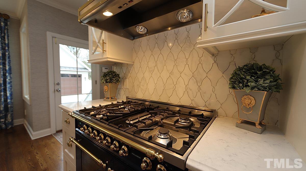 414 Yarmouth Road Raleigh, NC 27608 - Photo 18 of 42 a kitchen with a stove and a window