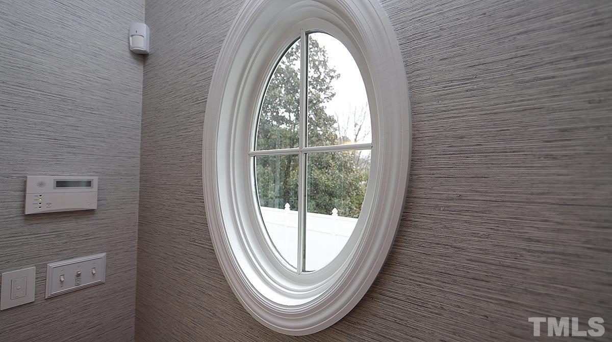 414 Yarmouth Road Raleigh, NC 27608 - Photo 21 of 42 a view of a hallway with window and a mirror