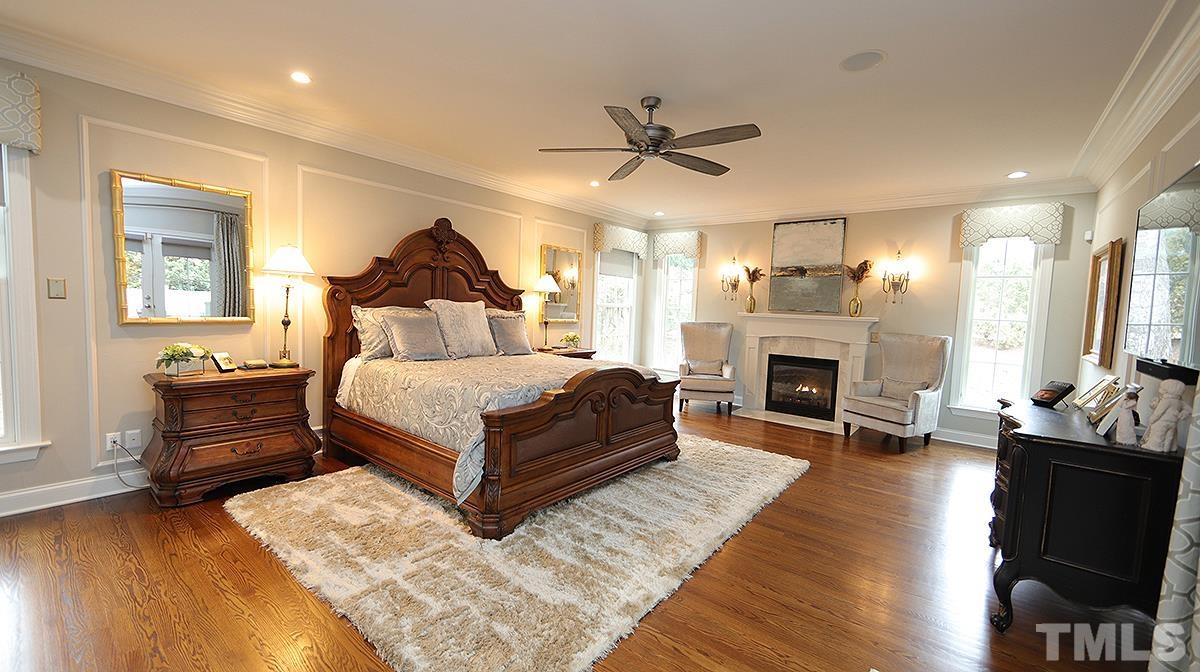 414 Yarmouth Road Raleigh, NC 27608 - Photo 28 of 42 a spacious bedroom with a bed and a fireplace