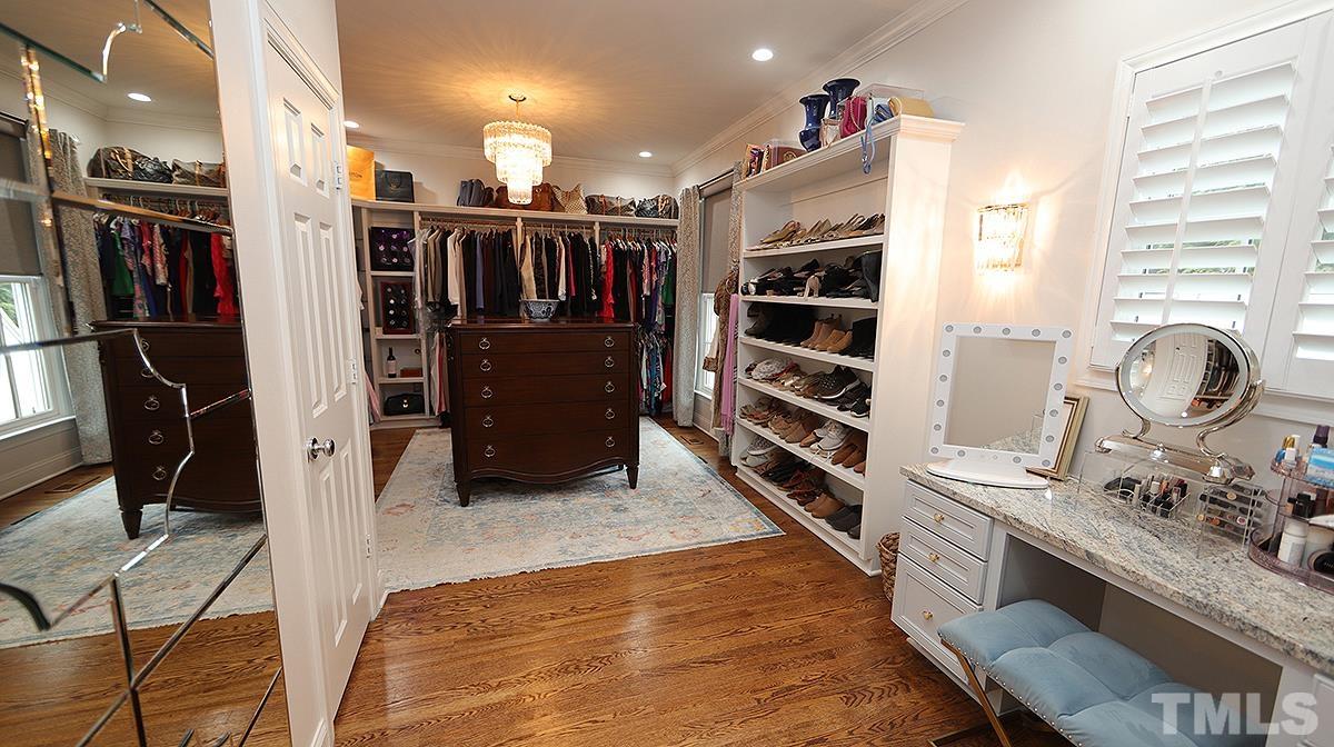 414 Yarmouth Road Raleigh, NC 27608 - Photo 30 of 42 a walk in closet with clothes and shoes