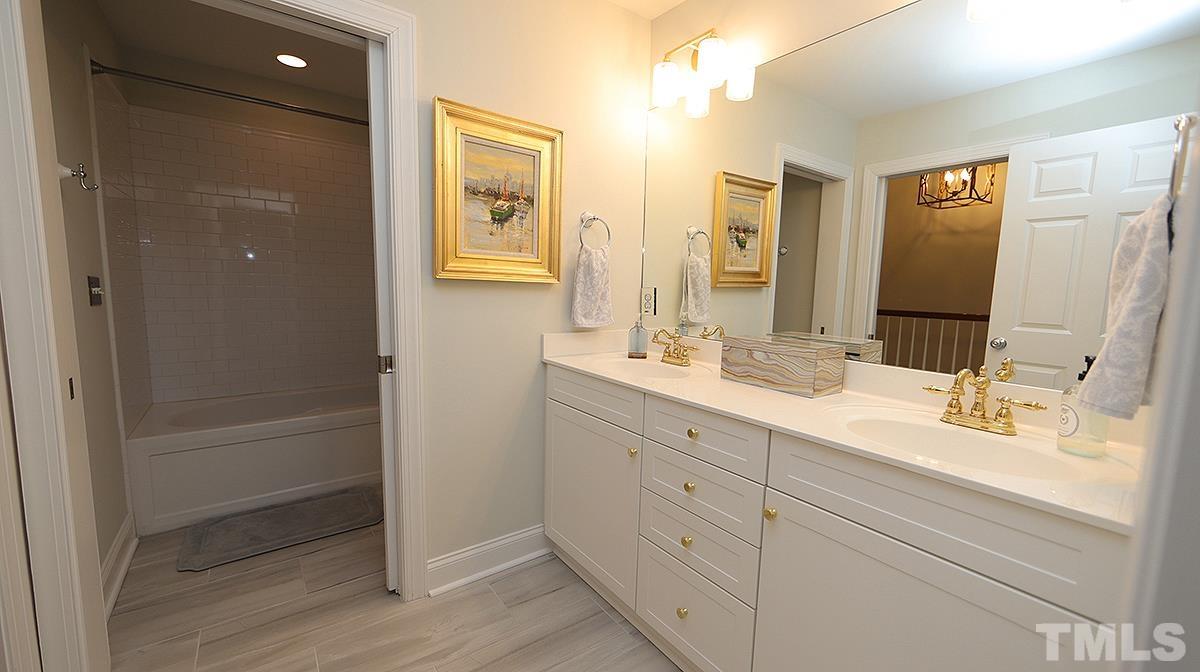 414 Yarmouth Road Raleigh, NC 27608 - Photo 34 of 42 a bathroom with double vanity sink and a mirror