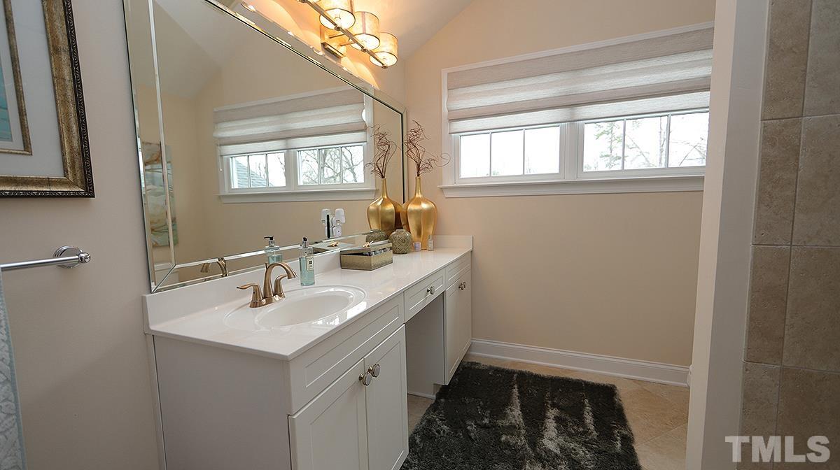 414 Yarmouth Road Raleigh, NC 27608 - Photo 36 of 42 a bathroom with 2 sink and a window