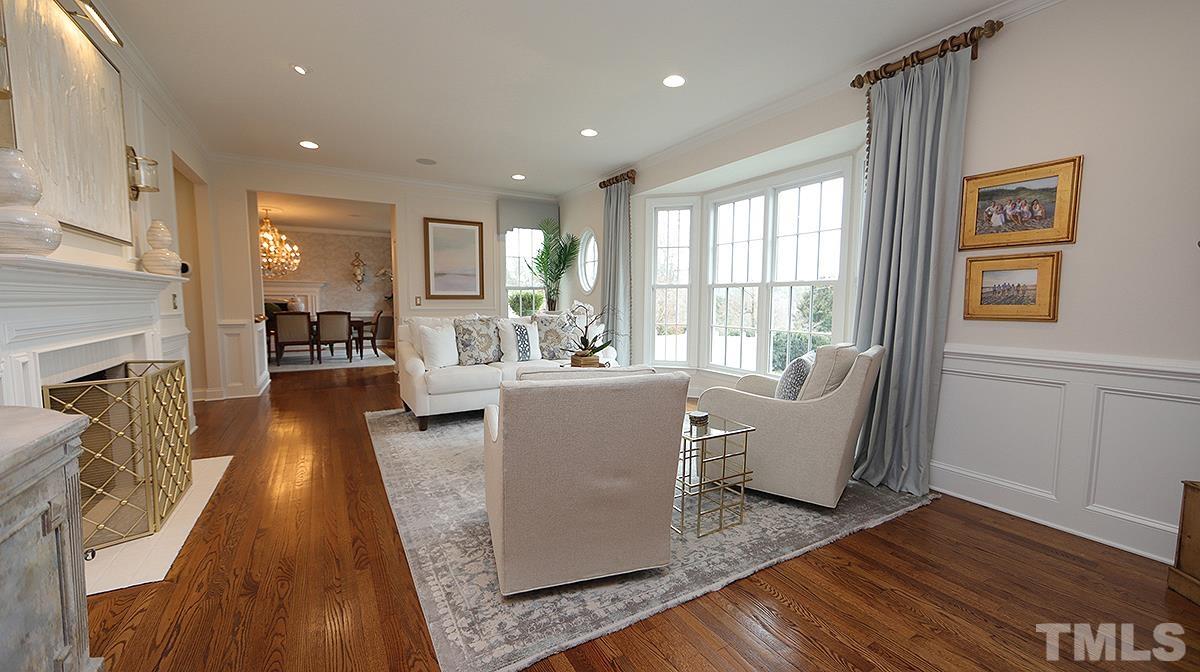 414 Yarmouth Road Raleigh, NC 27608 - Photo 9 of 42 a living room with fireplace furniture wooden floor and a table