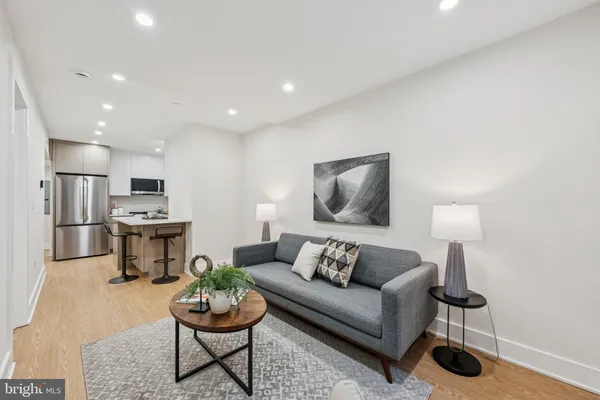 a living room with furniture and a wooden floor