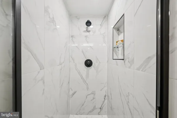 a bedroom with bed and a white cabinet