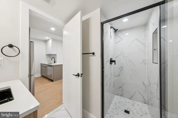 a bathroom with a glass shower door