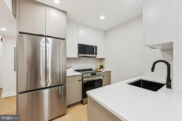 a kitchen with refrigerator and microwave