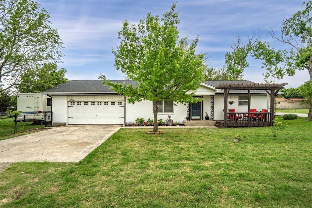 417 West 8th Street Justin, TX 76247 - Photo 1 of 40 a view of a house with a yard and porch