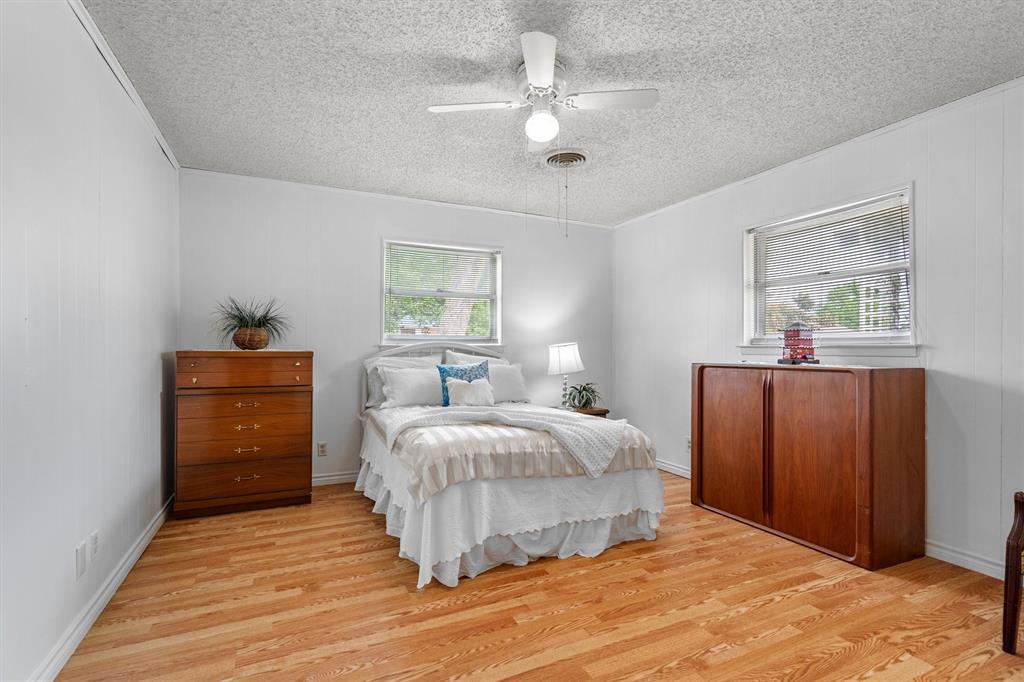 417 West 8th Street Justin, TX 76247 - Photo 15 of 40 a bedroom with a bed and a dresser