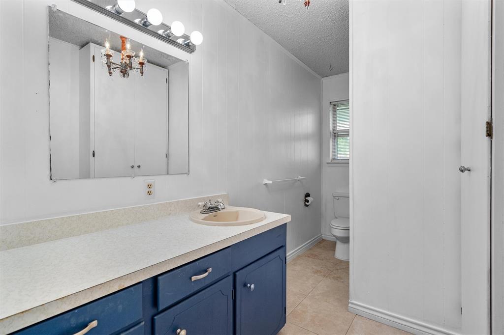 417 West 8th Street Justin, TX 76247 - Photo 19 of 40 a bathroom with a sink and a mirror