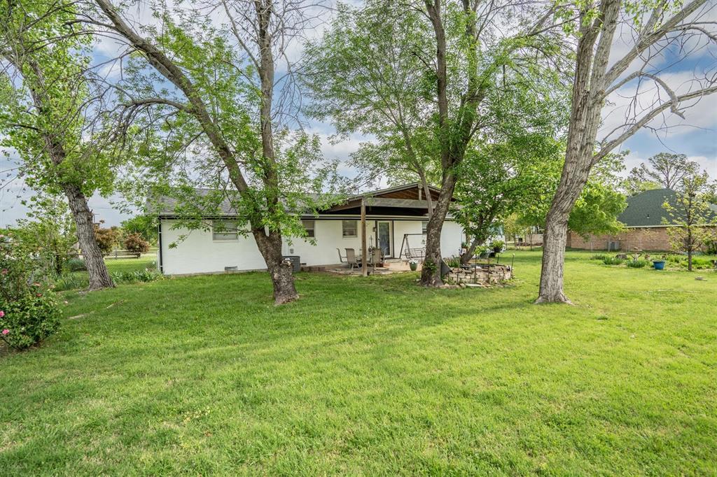 417 West 8th Street Justin, TX 76247 - Photo 26 of 40 a view of a house with yard and tree s
