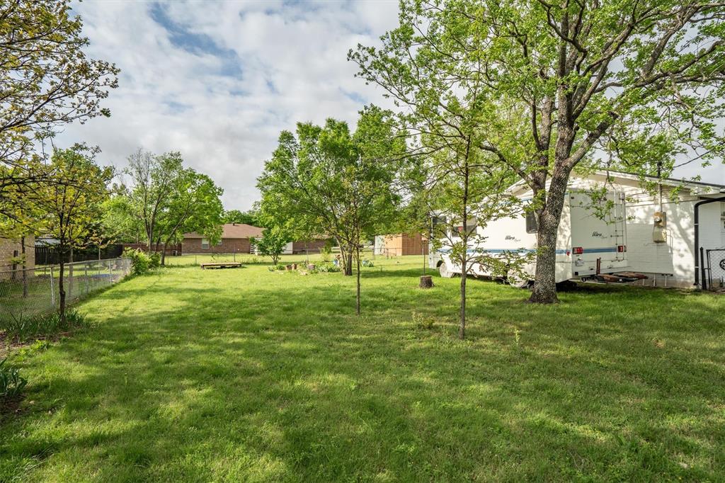 417 West 8th Street Justin, TX 76247 - Photo 27 of 40 a green field with lots of trees