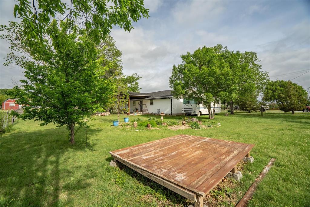 417 West 8th Street Justin, TX 76247 - Photo 28 of 40 a view of a backyard with a garden and plants