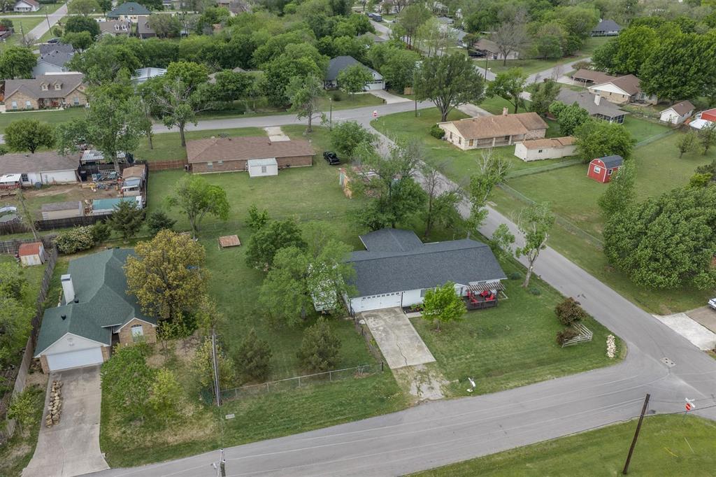 417 West 8th Street Justin, TX 76247 - Photo 31 of 40 an aerial view of residential houses with outdoor space and trees
