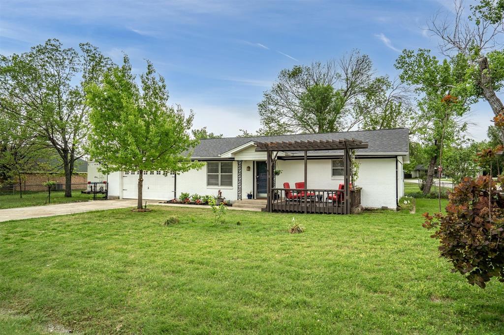 417 West 8th Street Justin, TX 76247 - Photo 32 of 40 a view of a house with a yard and sitting area