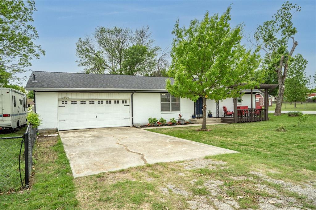 417 West 8th Street Justin, TX 76247 - Photo 33 of 40 a view of a house with a yard