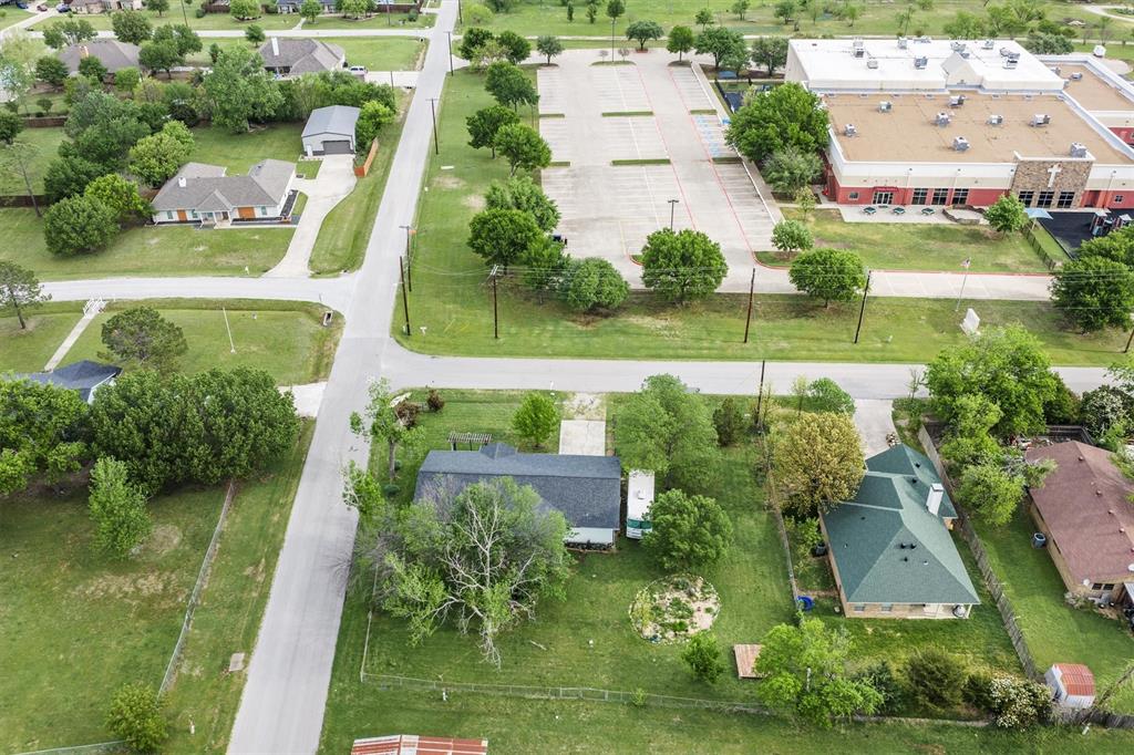417 West 8th Street Justin, TX 76247 - Photo 39 of 40 an aerial view of a house with a garden and houses