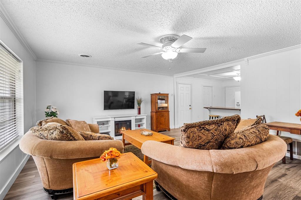 417 West 8th Street Justin, TX 76247 - Photo 7 of 40 a living room with furniture and a flat screen tv