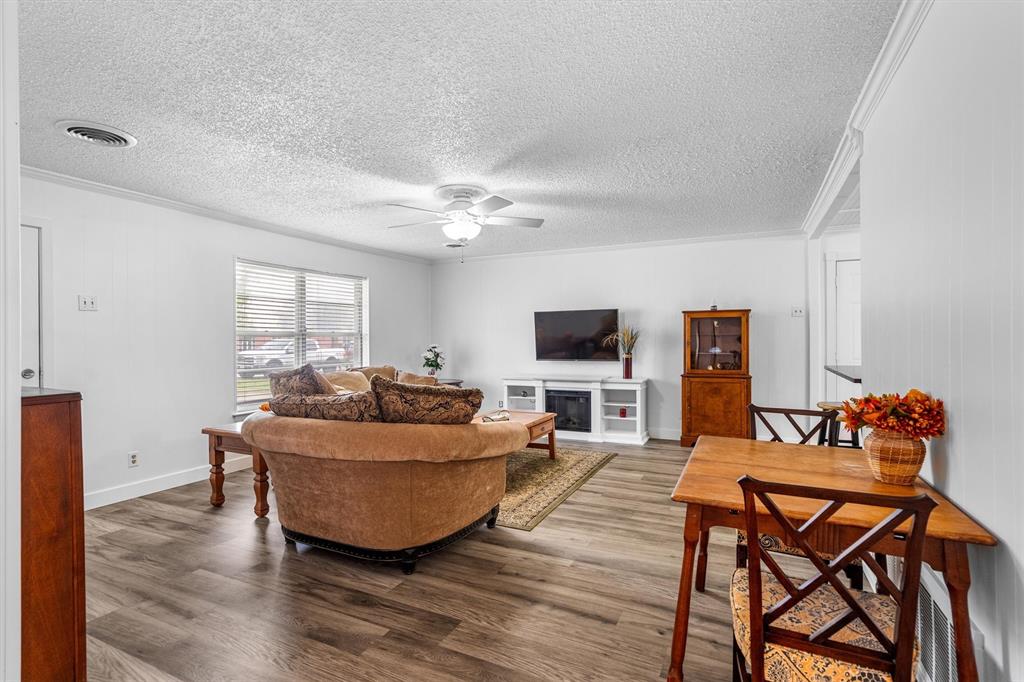 417 West 8th Street Justin, TX 76247 - Photo 8 of 40 a living room with furniture a flat screen tv and a window