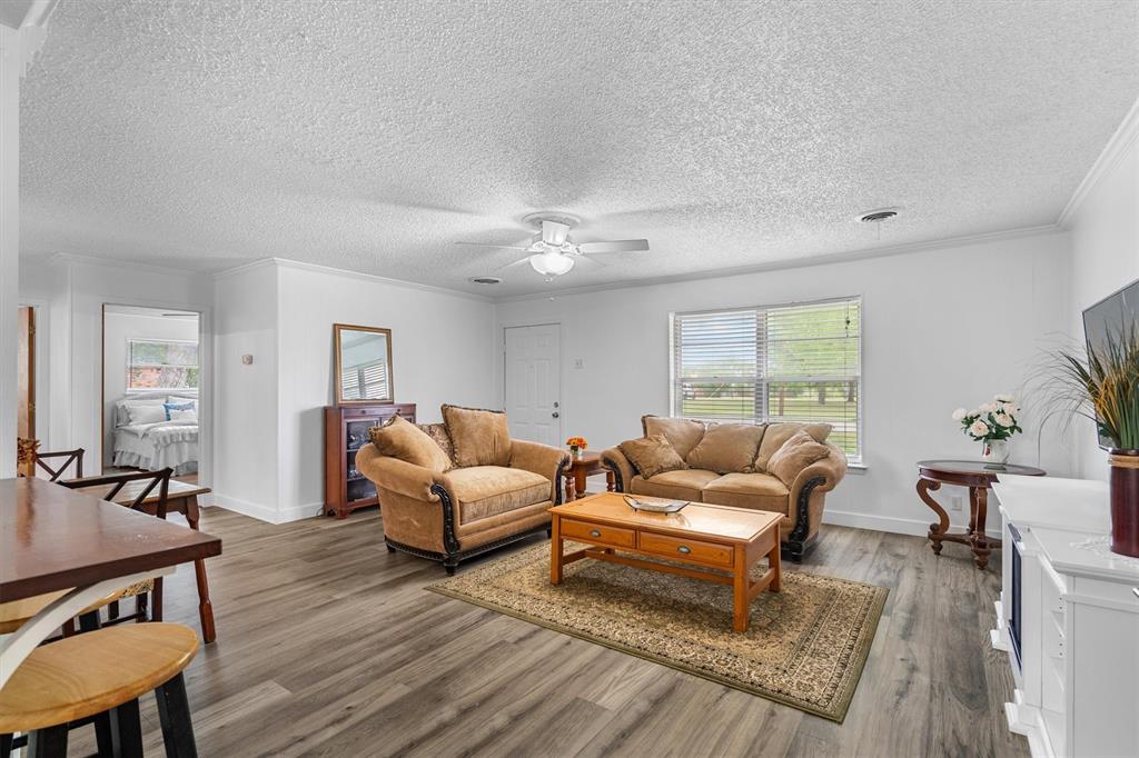 417 West 8th Street Justin, TX 76247 - Photo 10 of 40 a living room with furniture and wooden floor
