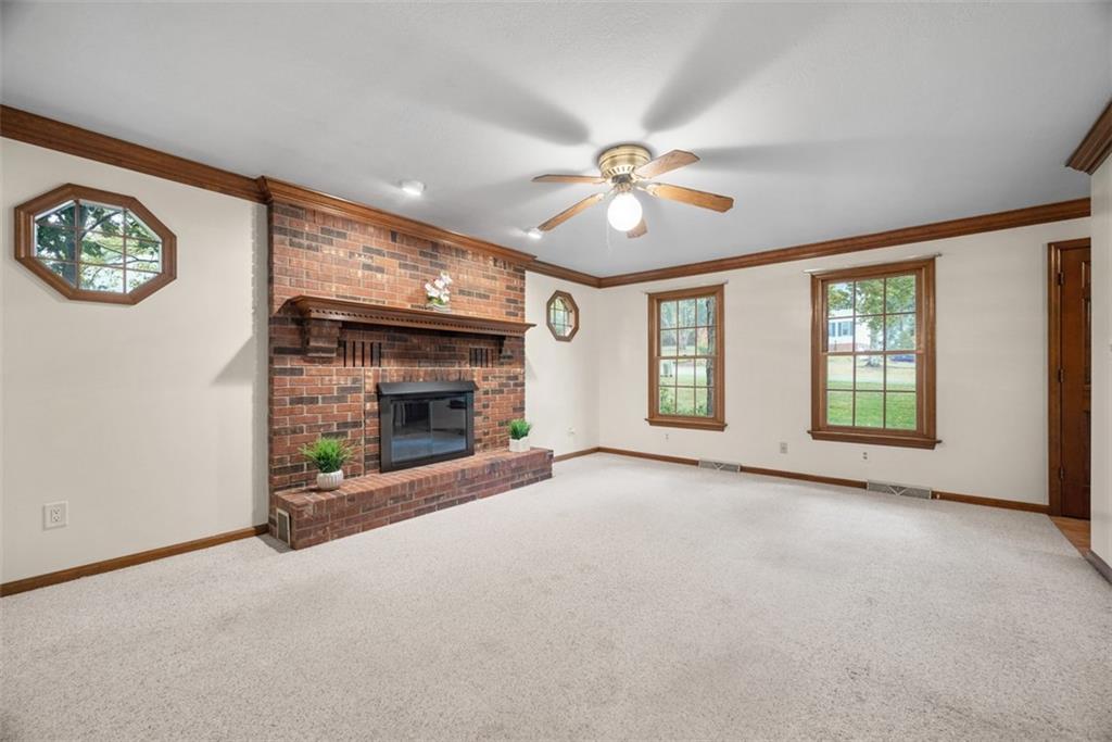 95 Firethorn Road Baden, PA 15005 - Photo 7 of 42 a view of an empty room with a fireplace and a window