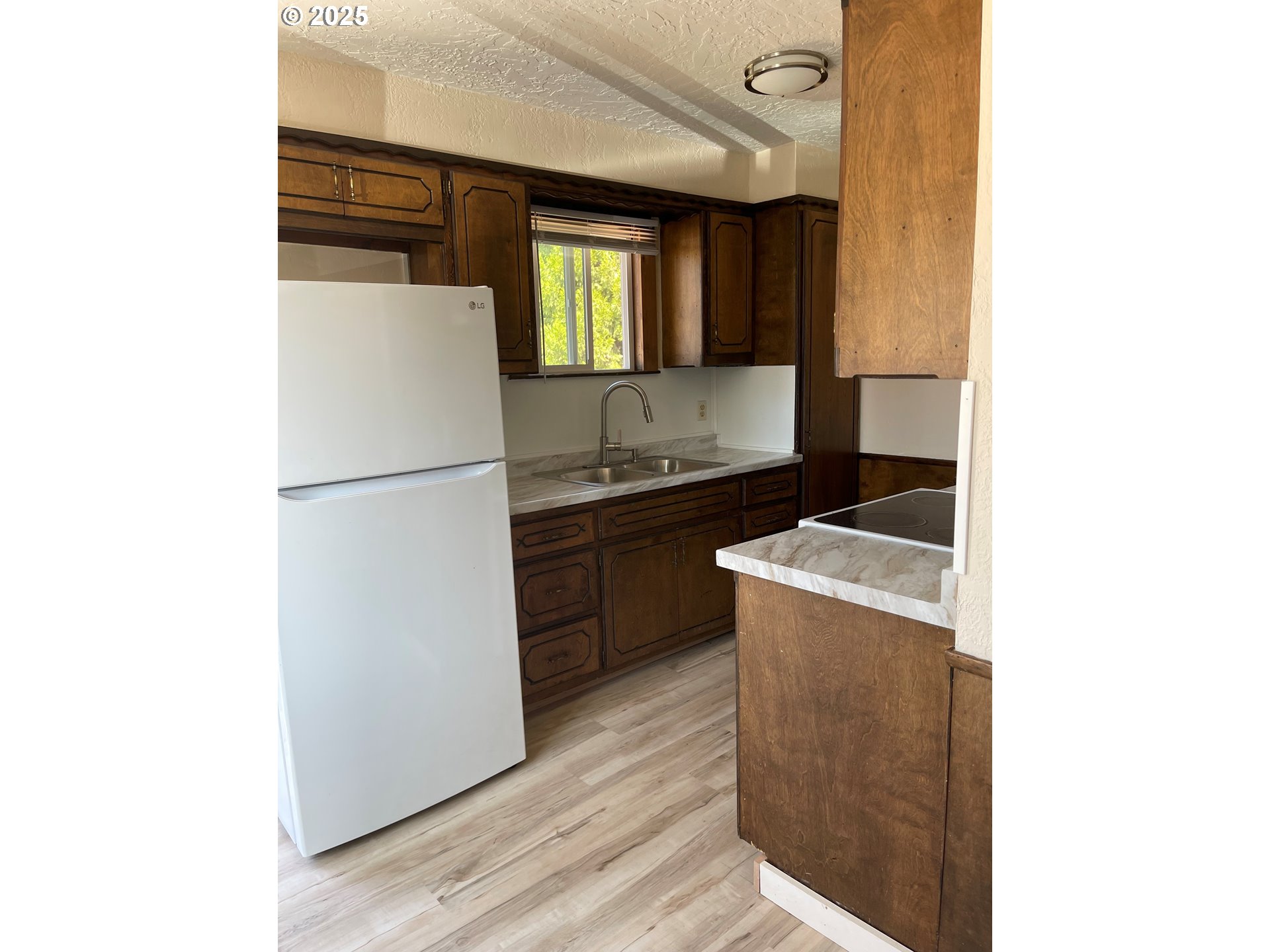 903 Southwest Pucker Huddle Road White Salmon, WA 98672 - Photo 4 of 10 a kitchen with a refrigerator sink and stove
