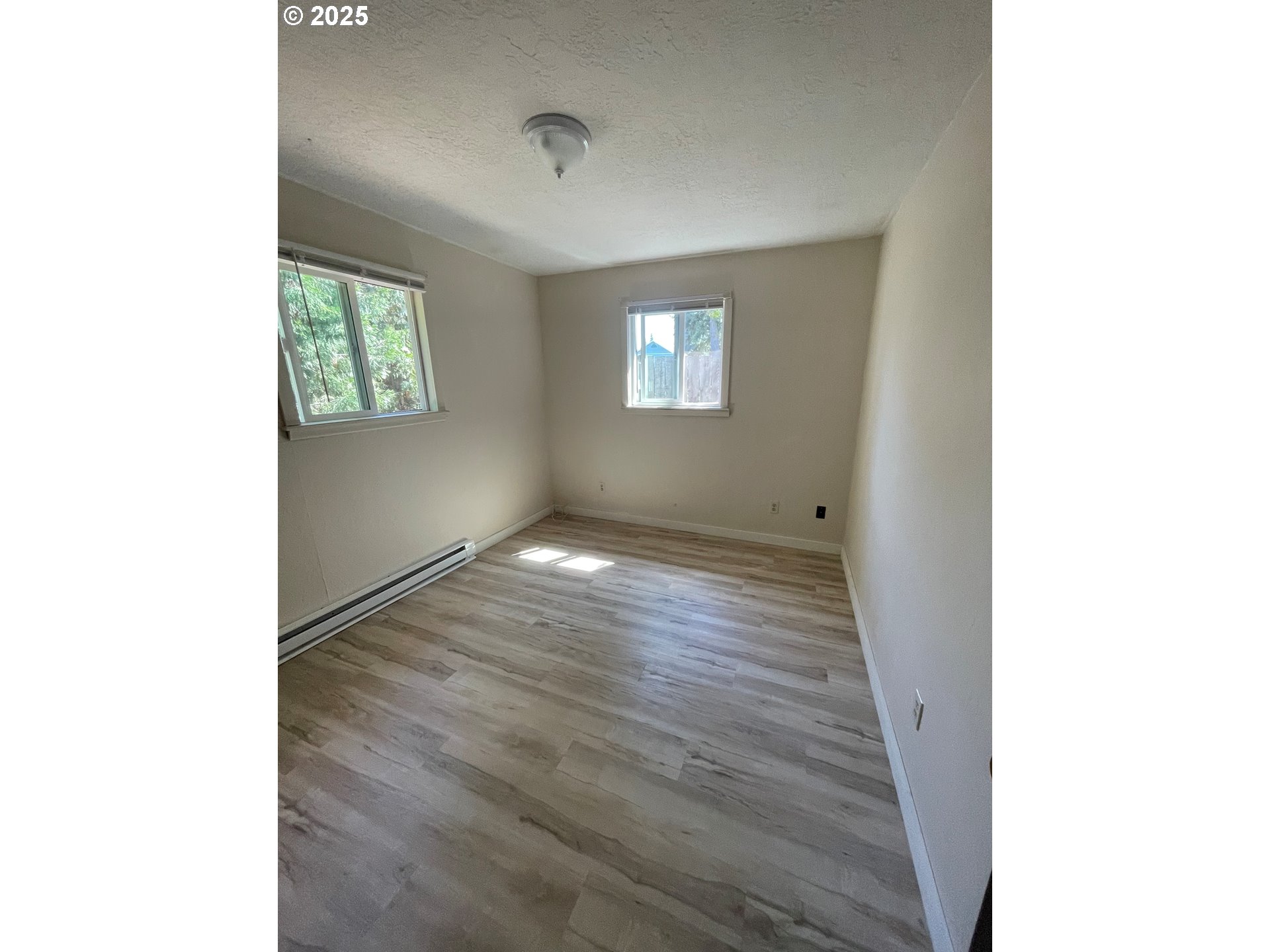903 Southwest Pucker Huddle Road White Salmon, WA 98672 - Photo 6 of 10 a view of an empty room with wooden floor and a window