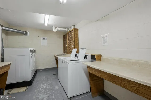 a utility room with cabinets washer and dryer