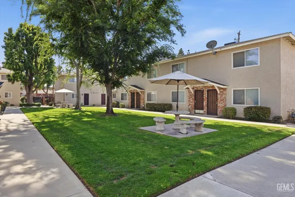 a view of a house with backyard sitting area and garden