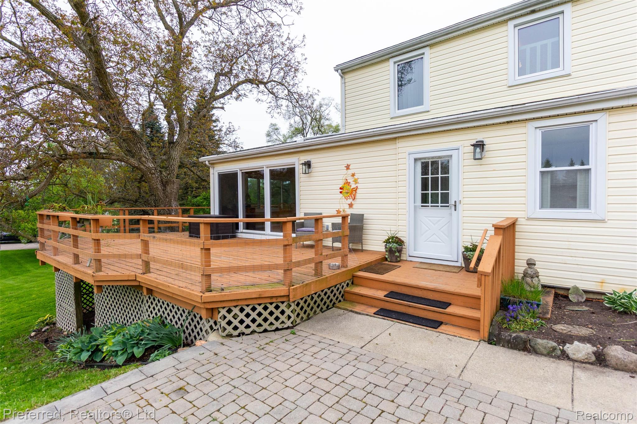 9840 Currie Road Northville, MI 48167 - Photo 46 of 62 Back of property with a wooden deck and a sunroom