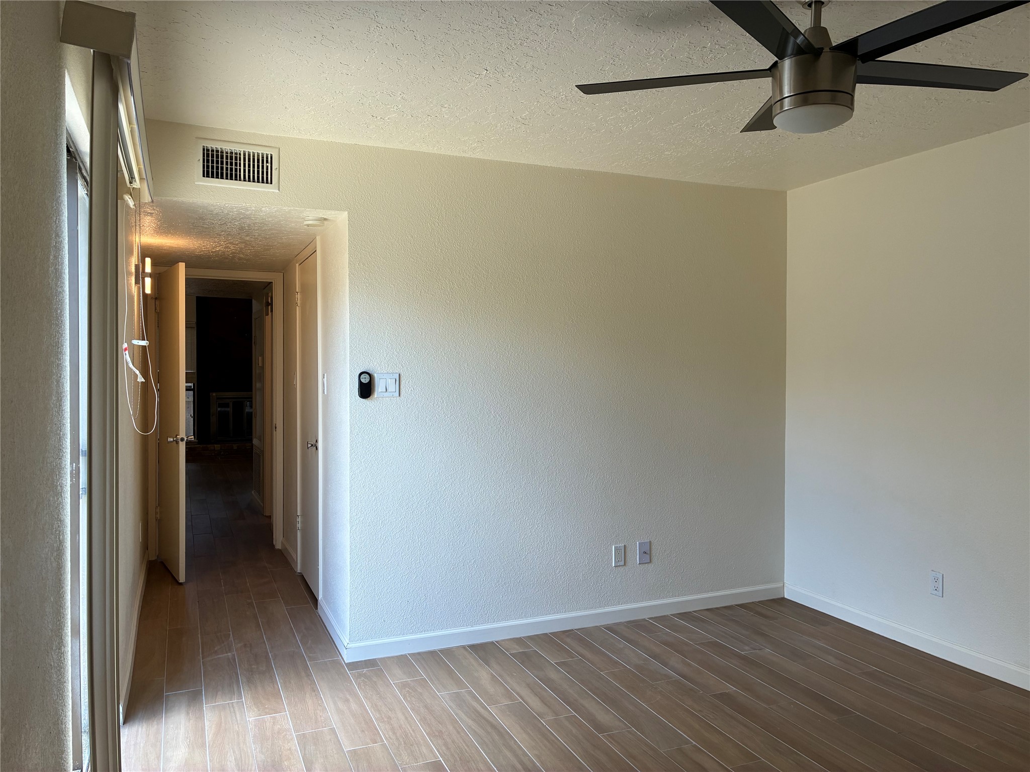 6401 Deihl Road, Unit 1011 Houston, TX 77092 - Photo 14 of 16 a view of an empty room with wooden floor