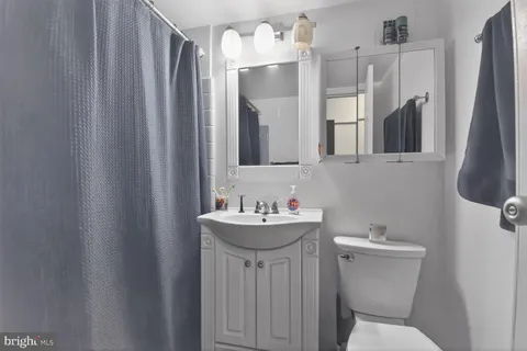 a bathroom with a sink mirror and toilet