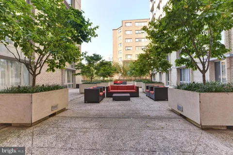 a wooden bench sitting in backside of a house