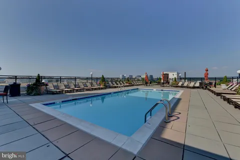 a terrace with outdoor seating and city view
