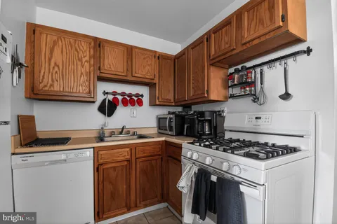 a kitchen with stainless steel appliances granite countertop a stove sink and cabinets