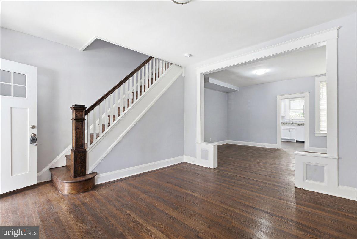 1231 North Potomac Street Baltimore, MD 21213 - Photo 4 of 25 a view of an entryway with wooden floor and stairs