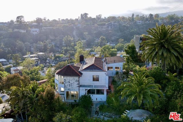 an aerial view of houses with trees
