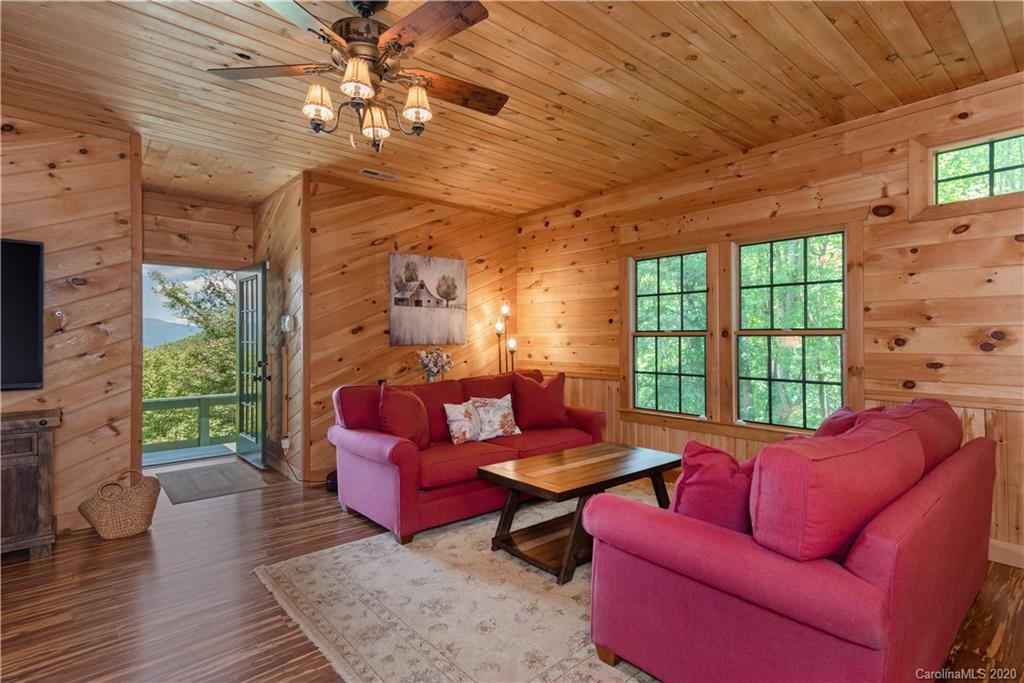 211 Lagrange Road, Unit TRACK 2 Waynesville, NC 28786 - Photo 11 of 48 a living room with furniture a fireplace and a chandelier