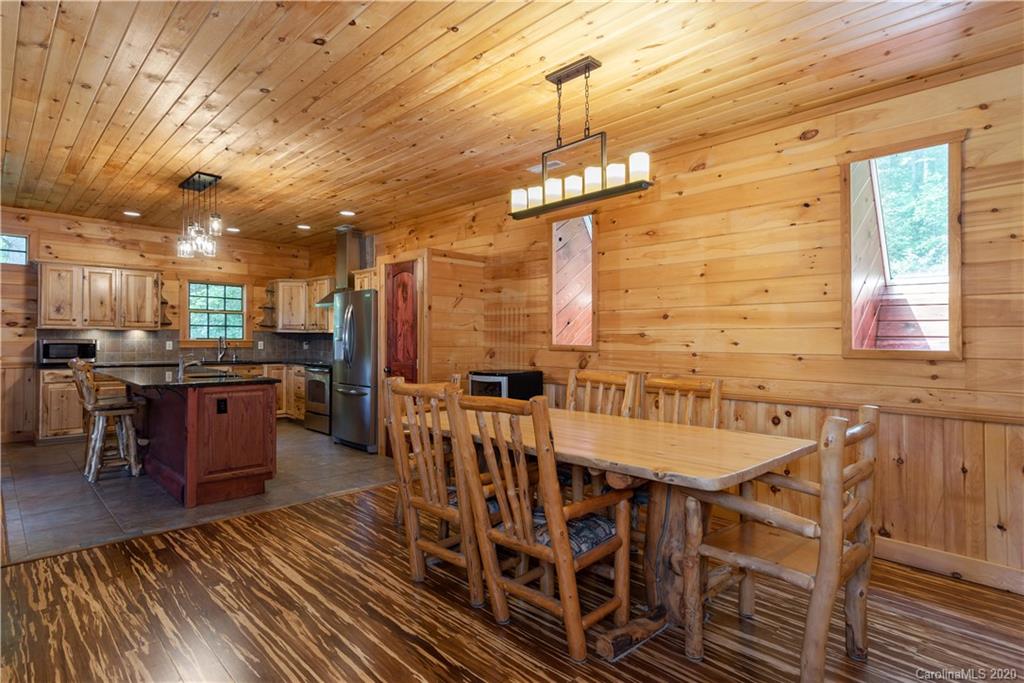 211 Lagrange Road, Unit TRACK 2 Waynesville, NC 28786 - Photo 16 of 48 a view of a dining room with furniture window and wooden floor