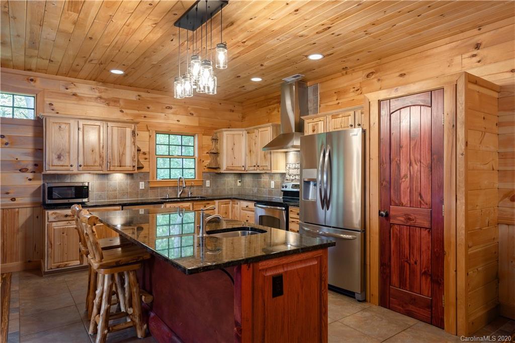 211 Lagrange Road, Unit TRACK 2 Waynesville, NC 28786 - Photo 17 of 48 a kitchen with stainless steel appliances granite countertop a sink refrigerator and cabinets