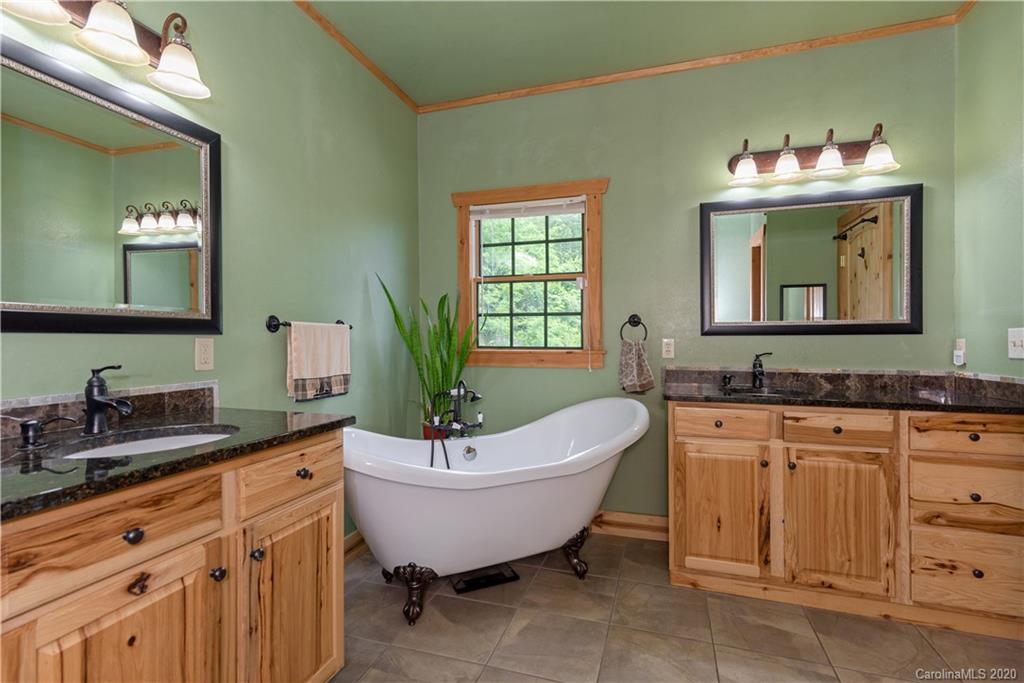 211 Lagrange Road, Unit TRACK 2 Waynesville, NC 28786 - Photo 24 of 48 a spacious bathroom with a bathtub sink and mirror