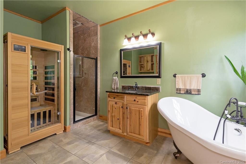 211 Lagrange Road, Unit TRACK 2 Waynesville, NC 28786 - Photo 25 of 48 a bathroom with a tub sink and mirror