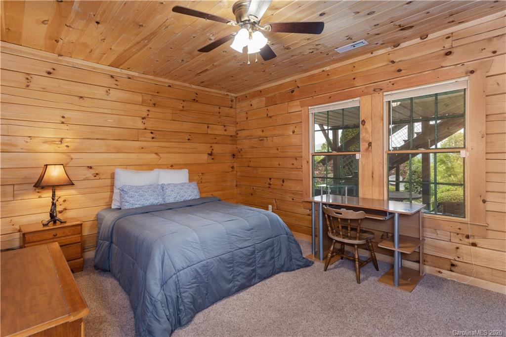 211 Lagrange Road, Unit TRACK 2 Waynesville, NC 28786 - Photo 28 of 48 a bedroom with a bed and a chandelier