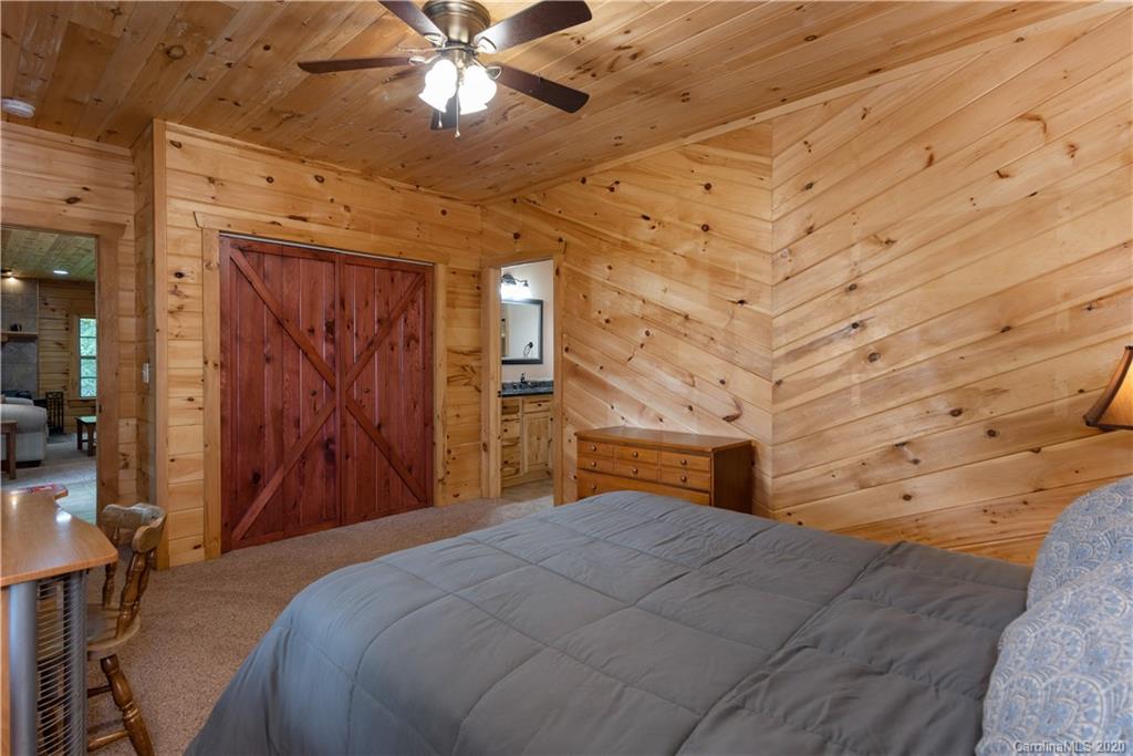 211 Lagrange Road, Unit TRACK 2 Waynesville, NC 28786 - Photo 29 of 48 a bedroom with a bed and a chandelier