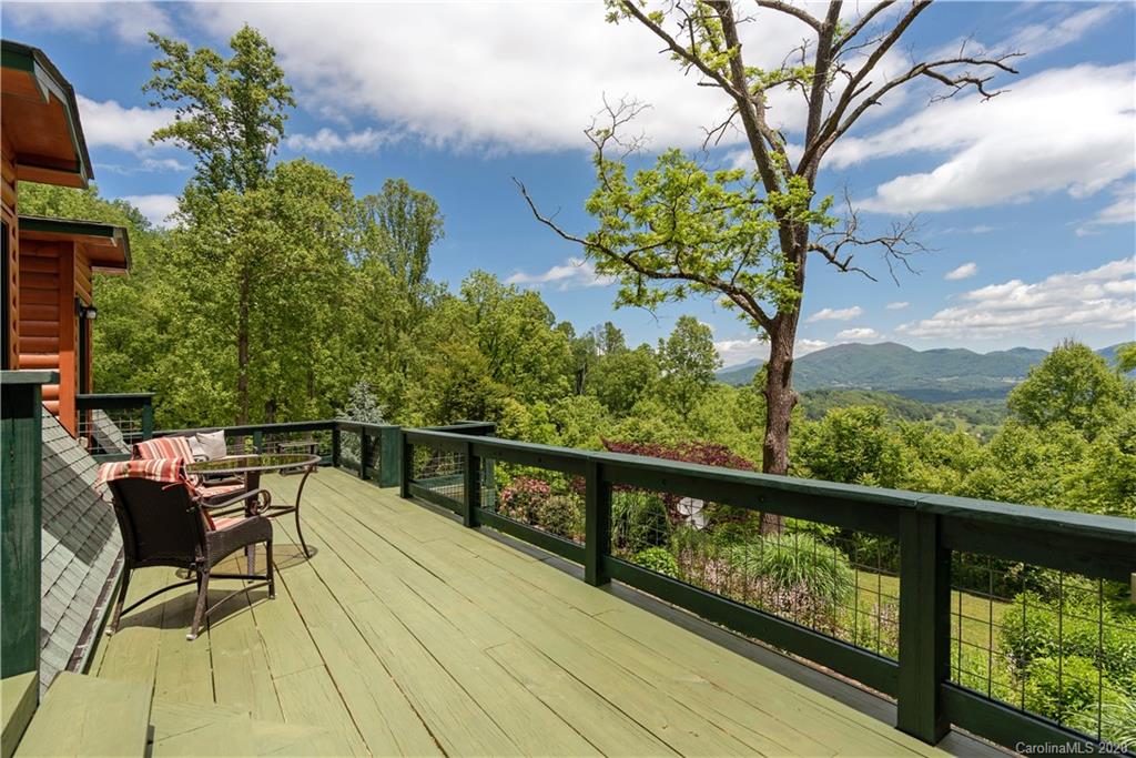 211 Lagrange Road, Unit TRACK 2 Waynesville, NC 28786 - Photo 4 of 48 a view of a chairs and table on the balcony