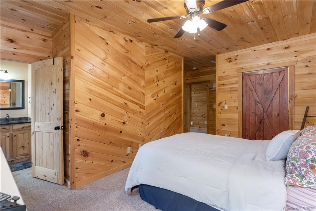 211 Lagrange Road, Unit TRACK 2 Waynesville, NC 28786 - Photo 32 of 48 a bedroom with a bed and a chandelier