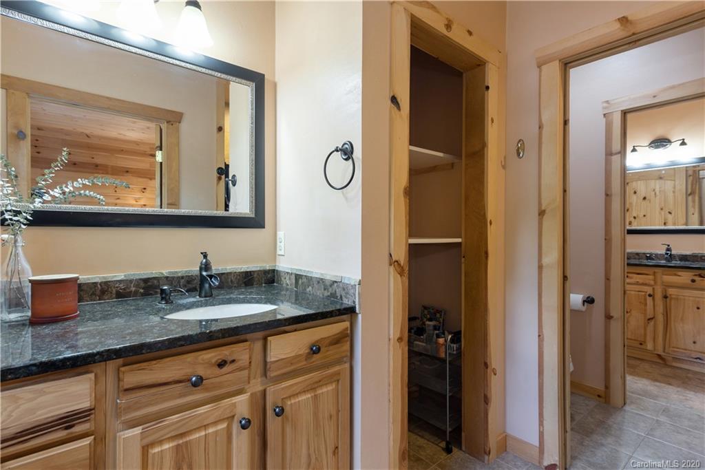 211 Lagrange Road, Unit TRACK 2 Waynesville, NC 28786 - Photo 33 of 48 a bathroom with a granite countertop sink vanity and mirror