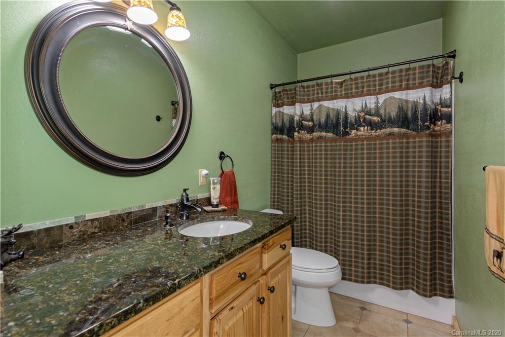211 Lagrange Road, Unit TRACK 2 Waynesville, NC 28786 - Photo 35 of 48 a bathroom with a granite countertop toilet sink and mirror