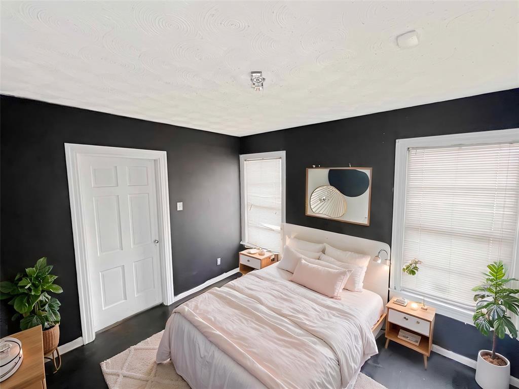 1010 Winters Street Dallas, TX 75216 - Photo 4 of 20 Interior room featuring dark walls, white trim, and dark wood-finish flooring