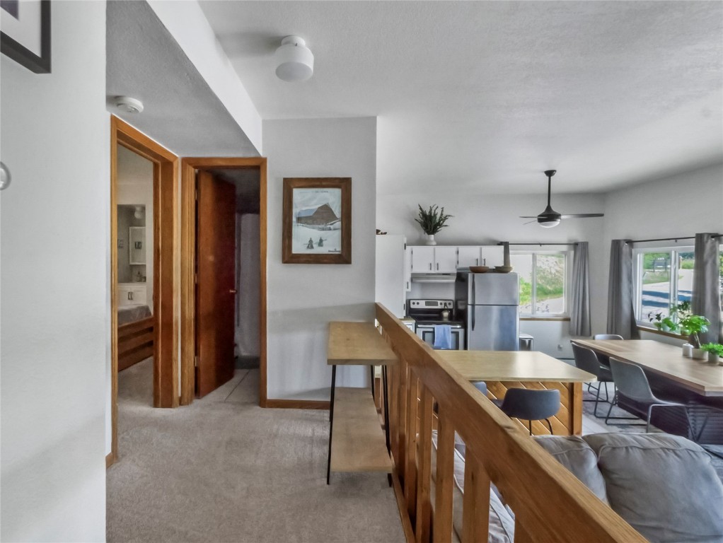 9876 Ryan Gulch Road, Unit 106 Silverthorne, CO 80498 - Photo 11 of 27 a living room with furniture and a wooden floor